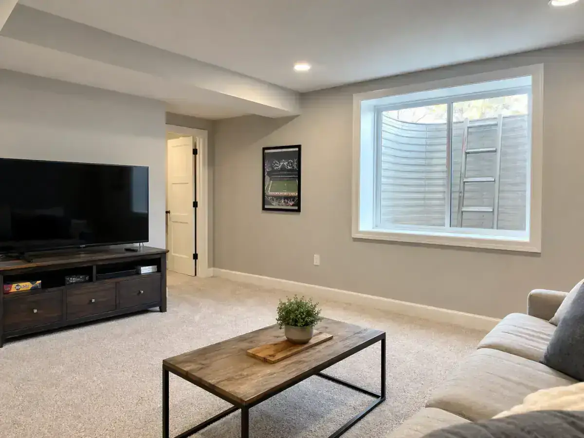 Interior trim and natural light from a code-compliant basement egress window in a Des Moines area home